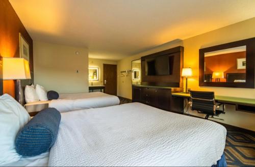 a hotel room with two beds and a desk at The Patch Lodge in Warroad