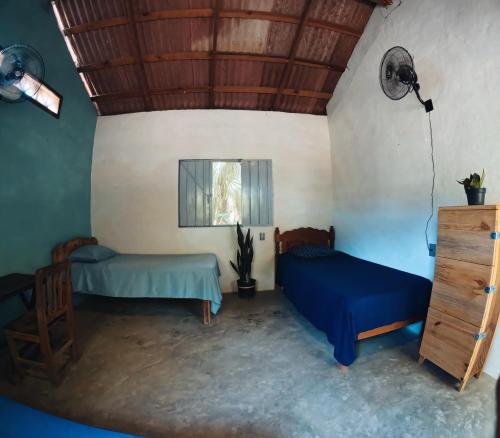 a room with two beds and a window at Cabañas La Escondida Mazunte in Mazunte