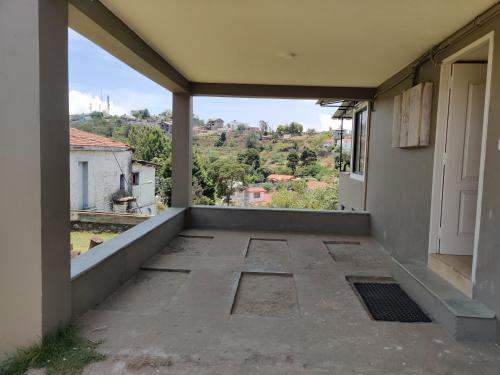 a view from the balcony of a house at Haven Guest House in Kodaikānāl