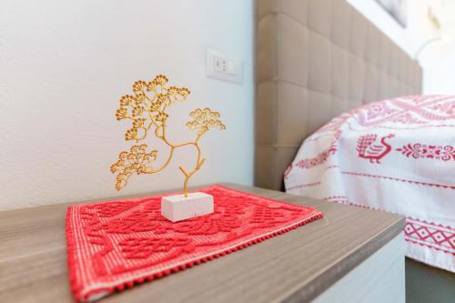 a table with a bonsai tree on top of it at B&B Ametista in Villasimius