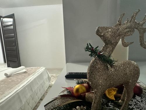a statue of a deer on a table with fruit at Casa DAIANA in Moisei