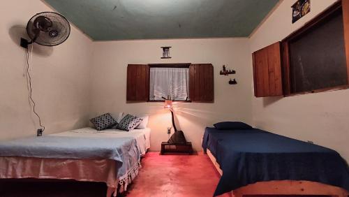 a room with two beds and a lamp in it at Cabañas La Escondida Mazunte in Mazunte