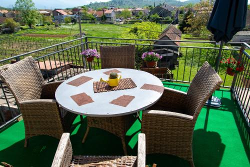 a table and chairs on a balcony with a view at Vila apartment Astorija 2 in Podgorica