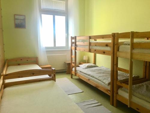 two bunk beds in a room with a window at Budova U dvojice in Nové Město na Moravě