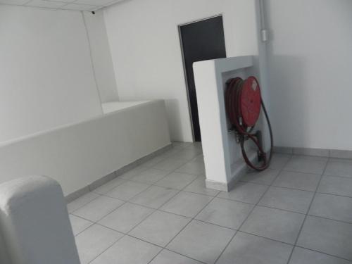 a room with a red backpack sitting on the floor at De Bliss Lodge in Johannesburg