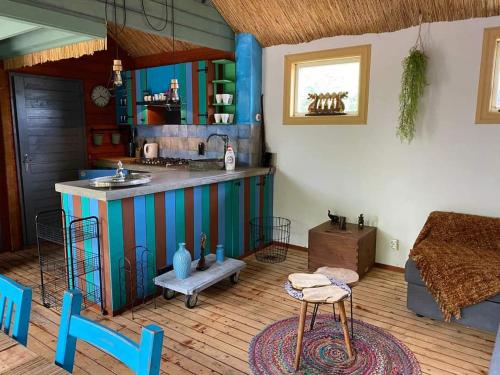 a kitchen with a sink and a counter in a room at Balistyle guesthouse incl Jacuzzi near Amsterdam and Schiphol in Vijfhuizen