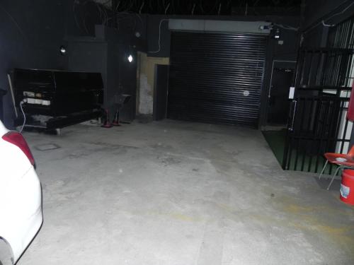 a garage with a garage door and a room with concrete at De Bliss Lodge in Johannesburg