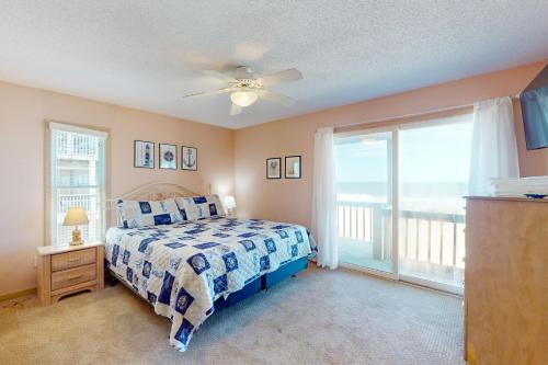 a bedroom with a bed and a large window at Argonauta #27-2 in Avon