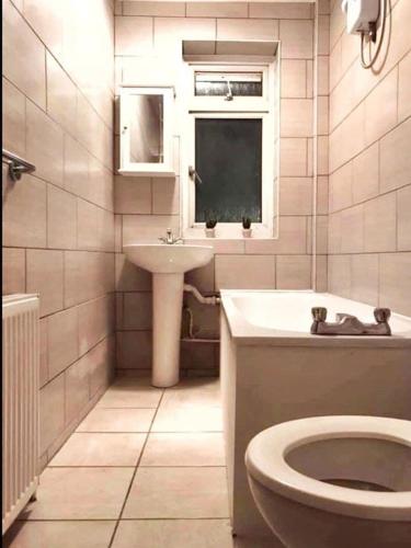 a bathroom with a toilet and a sink at Close to Central London in London