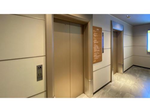 a row of elevators in a building with a sign at Rembrandt Hotel Atsugi - Vacation STAY 41676v in Atsugi