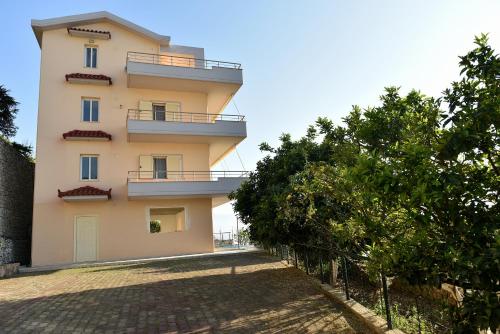 a building with balconies on the side of it at Vila Merkuri in Vlorë