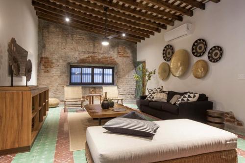 a living room with a couch and a table at Departamentos & Villa Monarka, 1 Block from Malecon! in La Paz