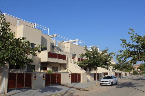 a white car parked in front of a building at Trendy and Modern New Built 2 Bedroom Apartment close to the Beach in Torre de la Horadada