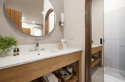a bathroom with a sink and a mirror at Departamentos & Villa Monarka, 1 Block from Malecon! in La Paz