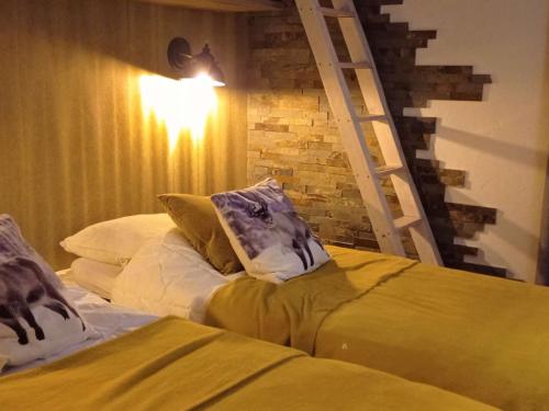 a bedroom with two beds with pillows and a ladder at Chalet Val Thorens, 6 pièces, 11 personnes - FR-1-545-27 in Val Thorens