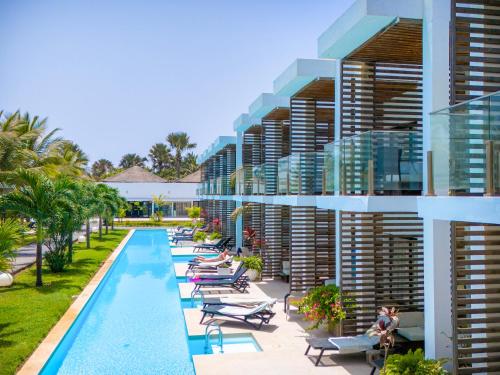 an exterior view of a resort with a swimming pool at Tamala Beach Resort in Kotu