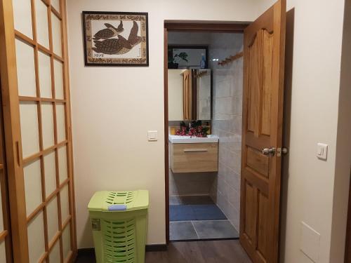 a bathroom with a toilet and a sink and a mirror at Villas TEAKAVEHERE - Fare OPUHI in Pirae