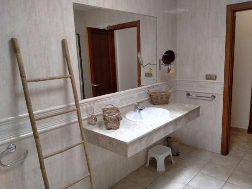 a bathroom with a sink and a mirror at Oasis Golf Villa in Caleta De Fuste