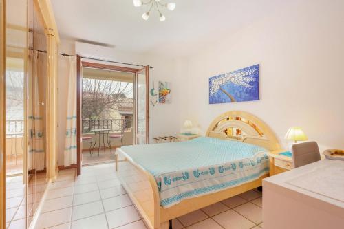 a bedroom with a bed and a balcony at B&B Ametista in Villasimius