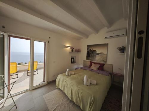 a bedroom with a bed and a balcony at Chalet Tango in Contrada Sauci Grande