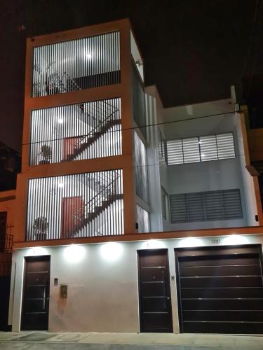 a building with two garage doors and a balcony at Dormitorio matrimonial 01 in Lima
