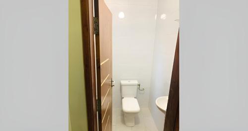 a bathroom with a toilet and a sink at Bénin Booking Buddy in Cotonou