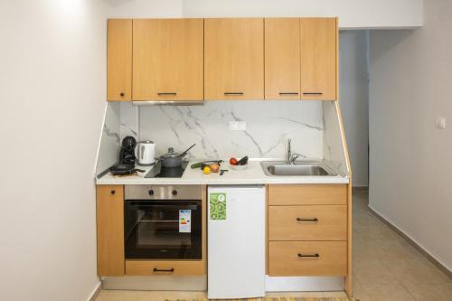 ネア・ペラモスにあるCHRISTOSの小さなキッチン(木製キャビネット、シンク付)