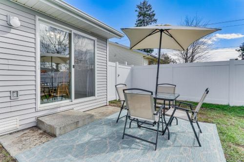 a patio with a table and chairs and an umbrella at Charming Home with Patio 3 Mi to Hayden Lake! in Hayden