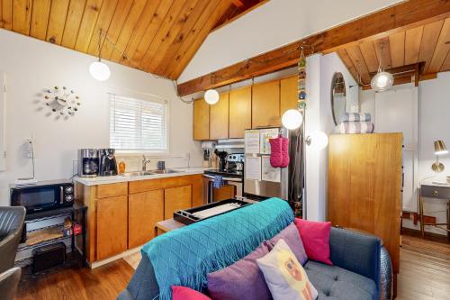 a living room with a couch and a kitchen at The Sea Lion in Seaside