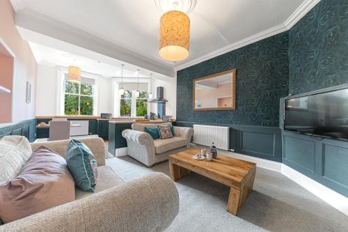 a living room with a couch and a tv at Ashbrooke Apartment Keswick at The Lairbeck in Keswick