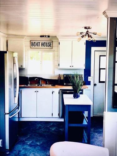 a kitchen with white cabinets and a boat house sign at Beautiful Oceanview Retreat 2 Bedroom Home in Port Hadlock