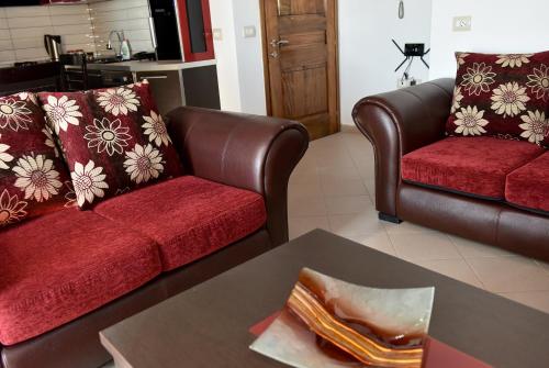 a living room with two couches and a table at Vila Merkuri in Vlorë