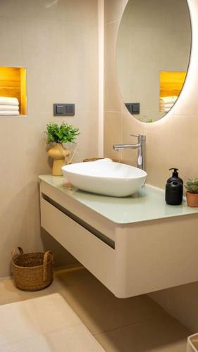 a bathroom with a white sink and a mirror at Cetinkaya Apart 3 in Kaş
