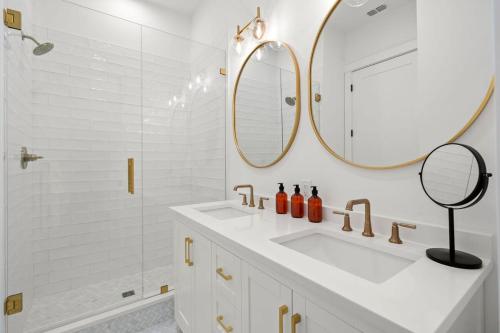 a white bathroom with a sink and a mirror at Pearl House at The Gemma by Brightwild in Clearwater Beach