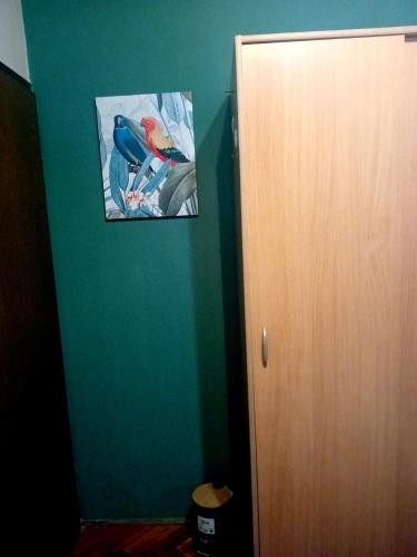 a green room with a picture of a bird on the wall at Guest House Cinderella in Herceg-Novi