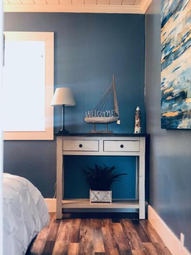 a bedroom with a bed and a table with a boat on the wall at Beautiful Oceanview Retreat 2 Bedroom Home in Port Hadlock