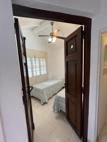 a room with a door open to a bedroom with a bed at SOBRE RIELES VAGON in San Lorenzo