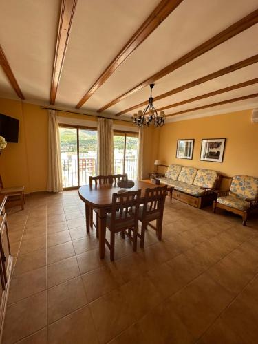 a living room with a table and a couch at Apartamentos Cuesta de la Cruz in Caravaca de la Cruz