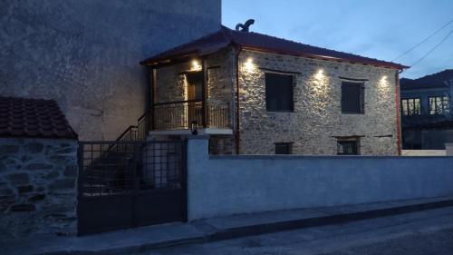 a brick house with a balcony and lights on it at Casa Lehovo in Lechovo