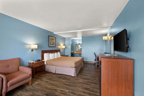 a hotel room with a bed and a flat screen tv at Americas Best Value Inn-Celina in Celina