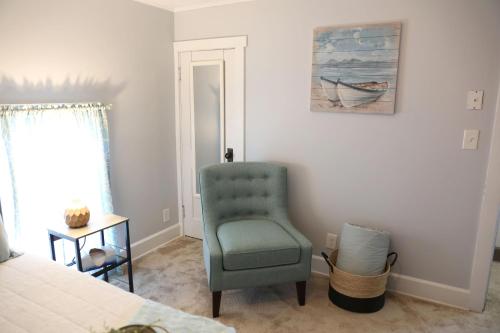 a bedroom with a green chair and a bed at Wayfarer Inn in Dalton