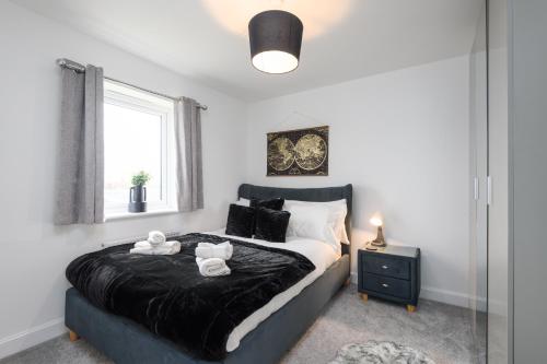 a bedroom with a bed with two stuffed animals on it at Spacious 3 Bedroom House In Canterbury with Garden and Driveway - Sleeps 7 in Canterbury