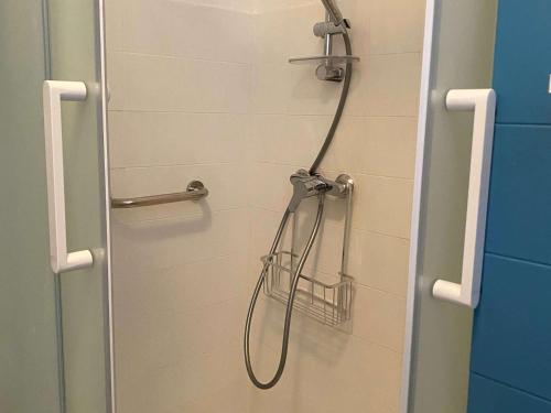une douche avec pommeau de douche dans une salle de bain dans l'établissement Charmant T1 à 5 min des Thermes, 2*, balcon, cuisine équipée, proche commerces - FR-1-553-179, à Balaruc-les-Bains