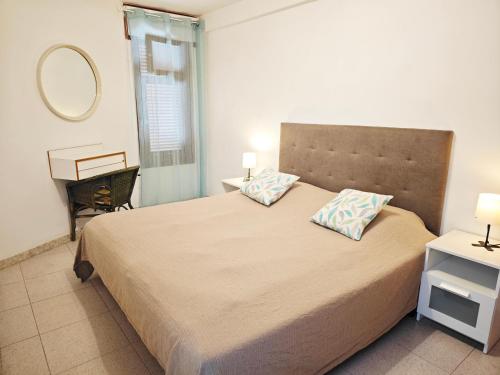 a bedroom with a large bed and a mirror at Blanco&Azul - Ocean View Balcony, Pool and Perfect Location in Playa de las Americas