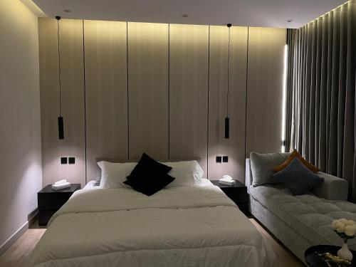 ein Schlafzimmer mit einem großen Bett und einem Sofa in der Unterkunft LUSSO Studio - استوديو لـوسـو الفندقي in Riad