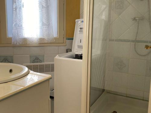 La petite salle de bains est pourvue d'un réfrigérateur et d'un four micro-ondes. dans l'établissement Charmant T2 avec clim et wifi, proche du port à Balaruc-les-Bains - FR-1-553-200, à Balaruc-les-Bains
