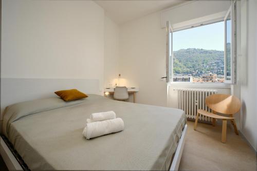 a white bedroom with a large bed with a window at White House & Como City Views in Como
