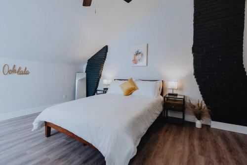 a bedroom with a large white bed and two lamps at Spacious 8BR-4BA Group HQ Patio&Games Soulard in Soulard