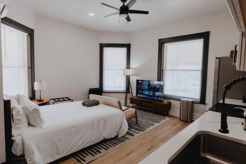 a bedroom with a bed and a bathroom with a sink at Chic Studio Walk to SMM SLU Hospital Grand in Tower Grove