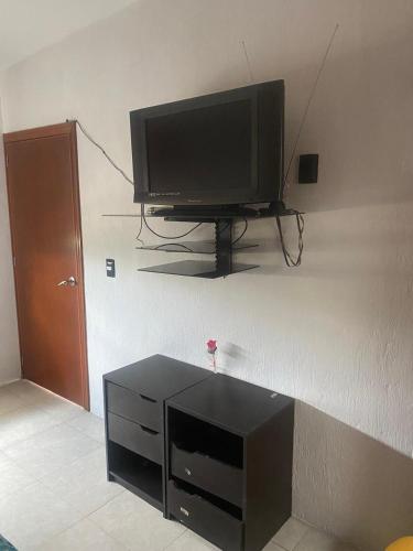 a flat screen tv sitting on a wall at Casa Muñoz in San Agustín